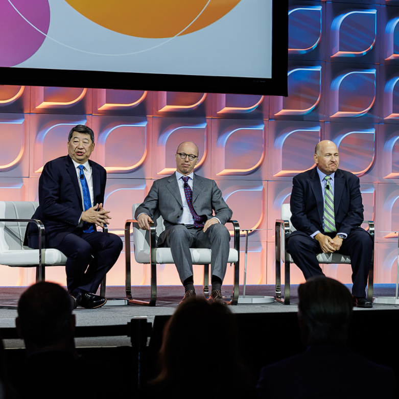 Dr. Chang sitting on stage on a panel