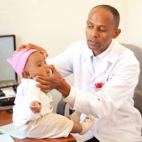 Surgeon with baby at desk